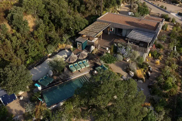 The villa and its pool from above, in the maquis